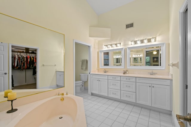 full bath with toilet, double vanity, visible vents, and a sink