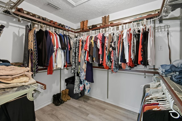 walk in closet with wood finished floors and visible vents