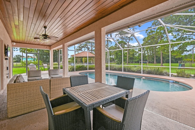 exterior space featuring a lanai, a patio area, and a ceiling fan