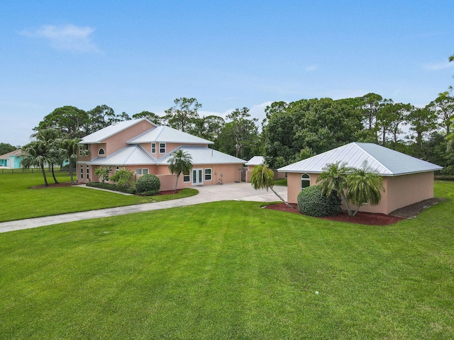 view of front of home featuring a front yard, concrete driveway, and stucco siding