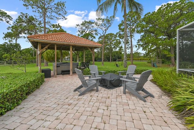 view of patio / terrace with a hot tub and a gazebo