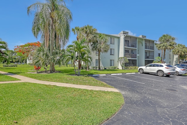 view of parking / parking lot with a yard