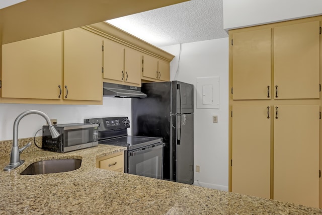 kitchen with light stone countertops, sink, black appliances, and a textured ceiling