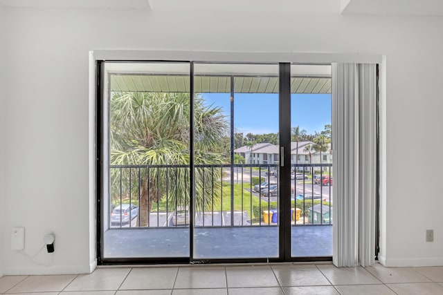 doorway to outside featuring light tile patterned flooring, a wealth of natural light, and french doors