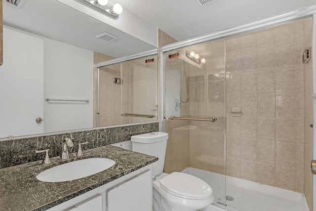 bathroom featuring vanity, toilet, and walk in shower