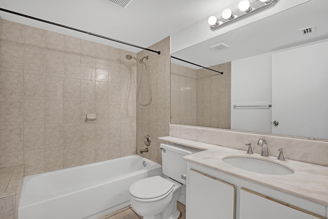 full bathroom featuring vanity, toilet, and tiled shower / bath