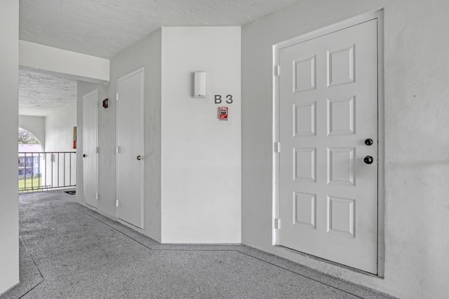 hallway featuring a textured ceiling