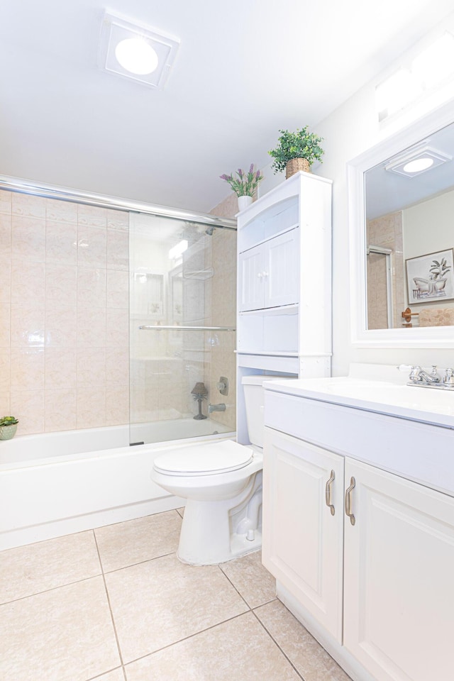 full bathroom featuring tile patterned floors, vanity, combined bath / shower with glass door, and toilet