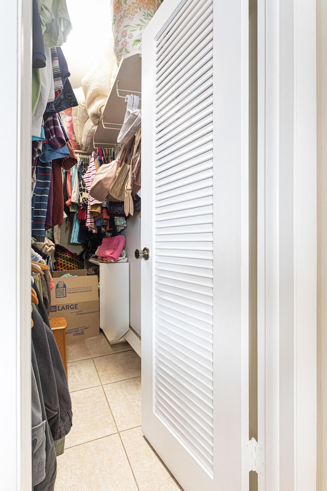 spacious closet with light tile patterned floors