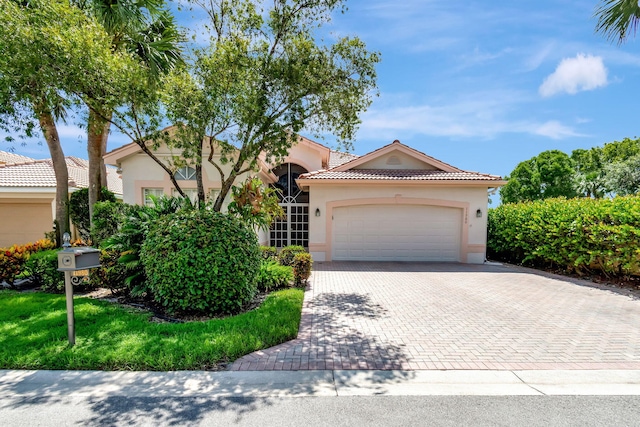 mediterranean / spanish-style home with a garage