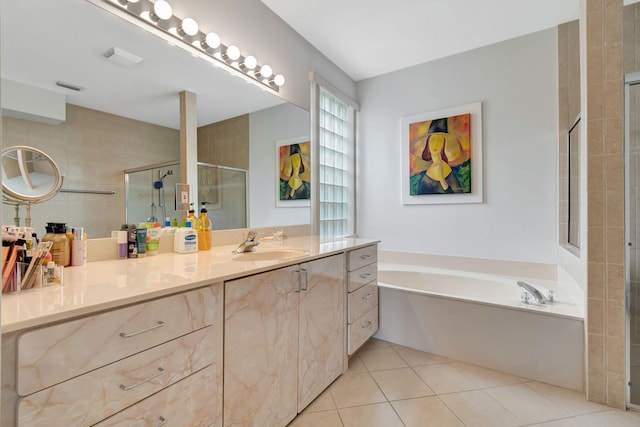 bathroom featuring tile patterned floors, vanity, and shower with separate bathtub