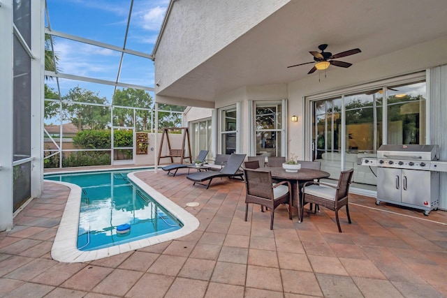 view of swimming pool with a lanai, a grill, ceiling fan, and a patio area