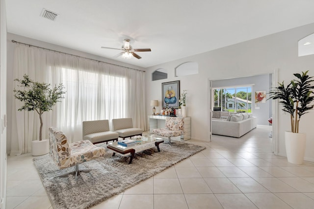 living room with ceiling fan and light tile patterned flooring