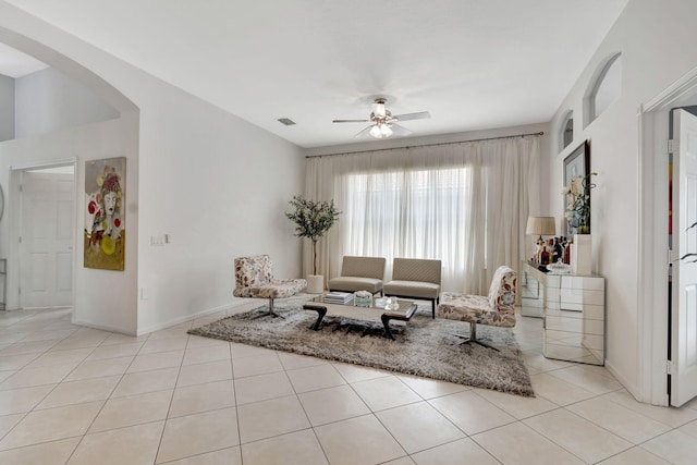 tiled living room featuring ceiling fan