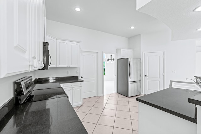 kitchen featuring a textured ceiling, stainless steel appliances, sink, white cabinets, and light tile patterned flooring