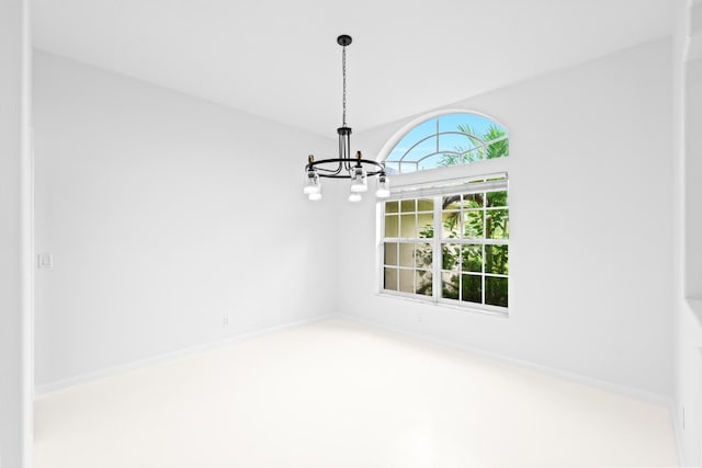 unfurnished dining area featuring carpet floors and a chandelier