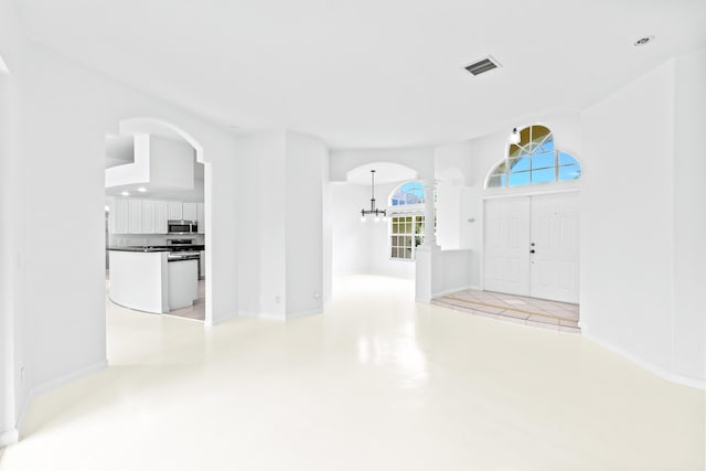 foyer entrance featuring an inviting chandelier