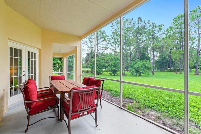 sunroom / solarium featuring french doors