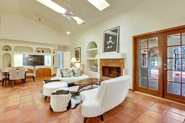 living room featuring french doors, ceiling fan, light tile patterned floors, built in features, and a fireplace