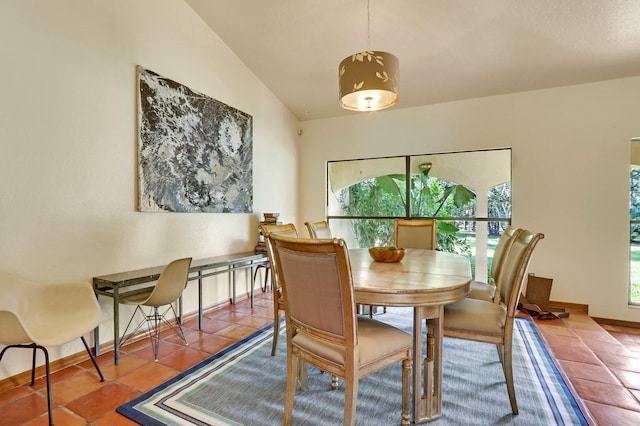 tiled dining area with vaulted ceiling and plenty of natural light