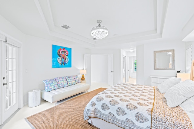 bedroom featuring a raised ceiling and multiple windows