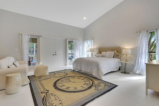 bedroom with access to outside, high vaulted ceiling, and multiple windows