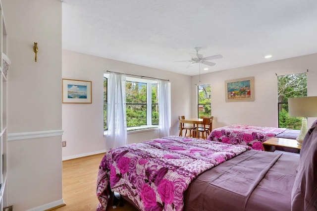 bedroom featuring ceiling fan and light hardwood / wood-style flooring