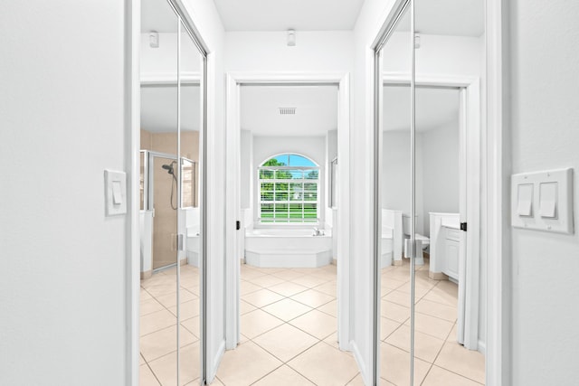 hallway featuring light tile patterned floors