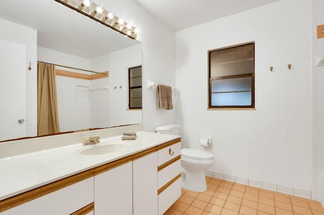 bathroom featuring a shower with shower curtain, vanity, tile patterned floors, and toilet