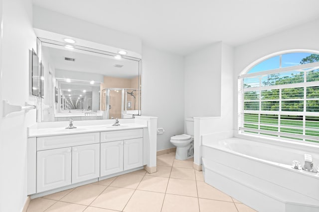 full bathroom featuring toilet, tile patterned flooring, vanity, and shower with separate bathtub