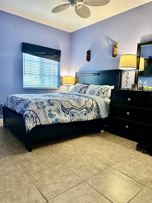 tiled bedroom with ceiling fan