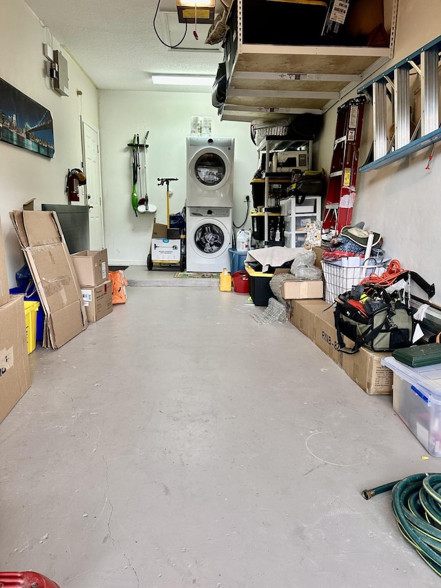 interior space featuring a garage door opener and stacked washing maching and dryer