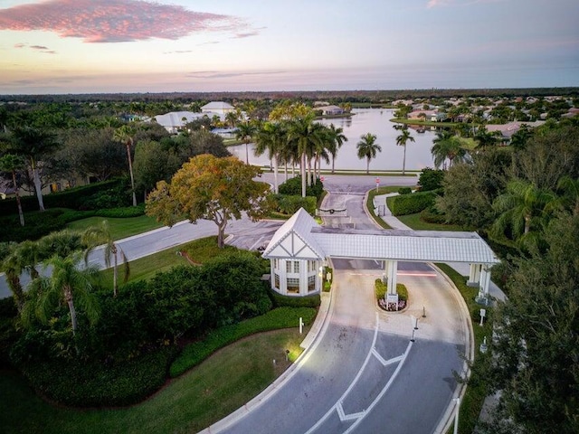 aerial view at dusk featuring a water view