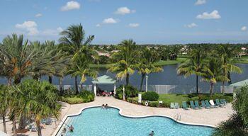 view of swimming pool with a patio and a water view