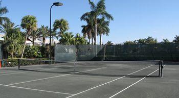 view of tennis court featuring basketball hoop