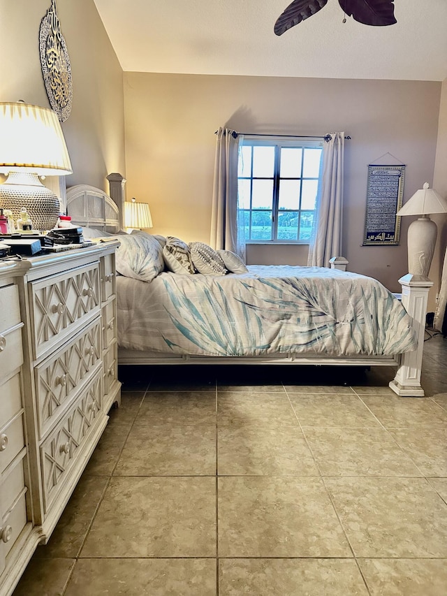 tiled bedroom featuring ceiling fan