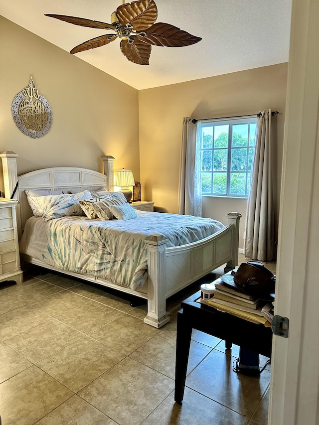 bedroom with ceiling fan and tile patterned flooring