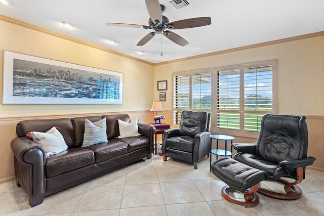 living room with light tile patterned floors, a textured ceiling, ceiling fan, and ornamental molding