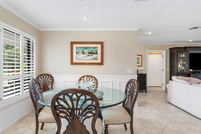 tiled dining space with ornamental molding