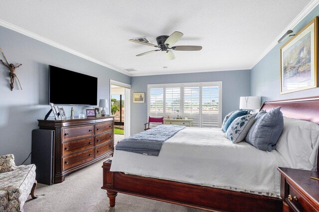 carpeted bedroom featuring ceiling fan, crown molding, and a textured ceiling