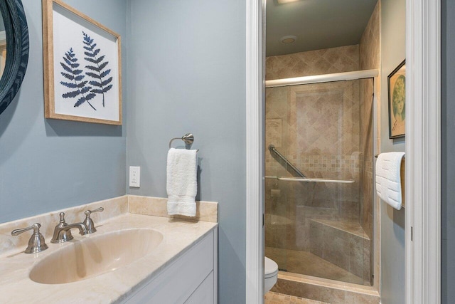 bathroom with vanity, toilet, and walk in shower