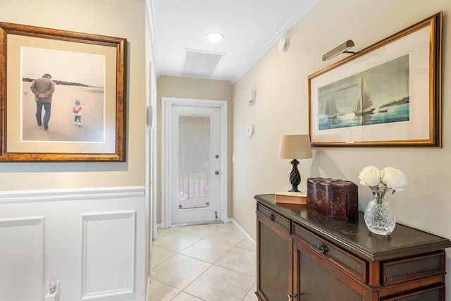 hallway featuring crown molding and light tile patterned flooring