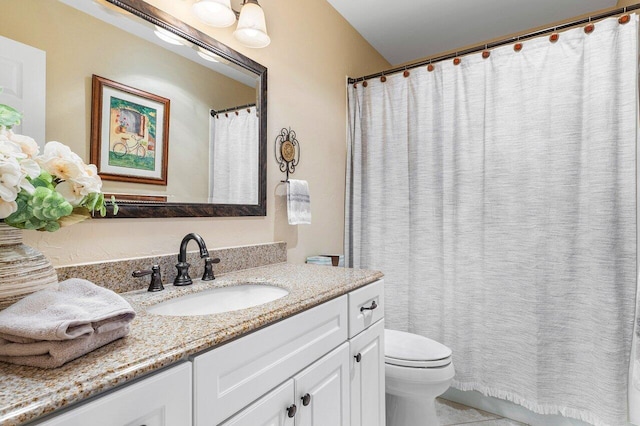 bathroom featuring toilet, vanity, and tile patterned floors