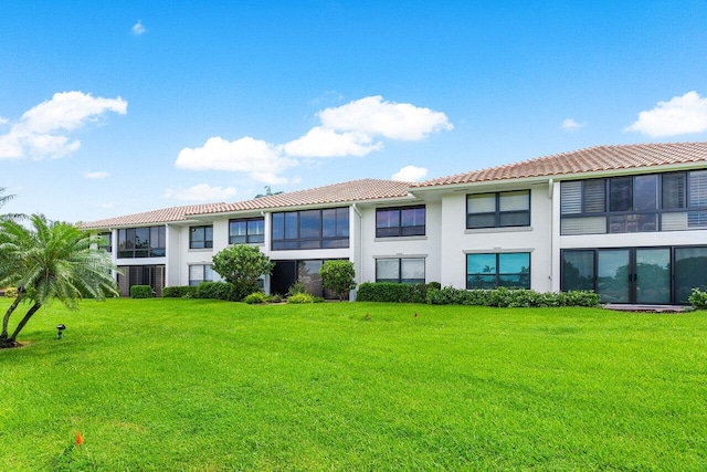 rear view of property with a lawn