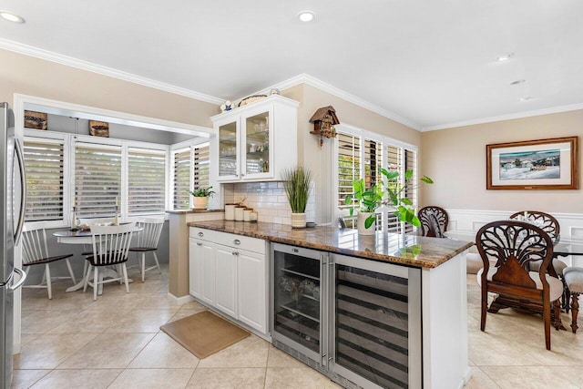 10093 Quail Covey Road Hibiscus N, Boynton Beach, FL 33436 - bar area featuring beverage cooler, crown molding, light tile patterned floors, recessed lighting, and wainscoting