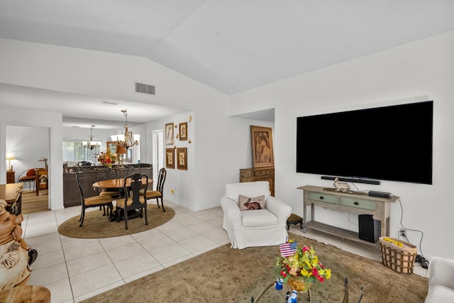 living room with vaulted ceiling, a chandelier, and light tile patterned flooring