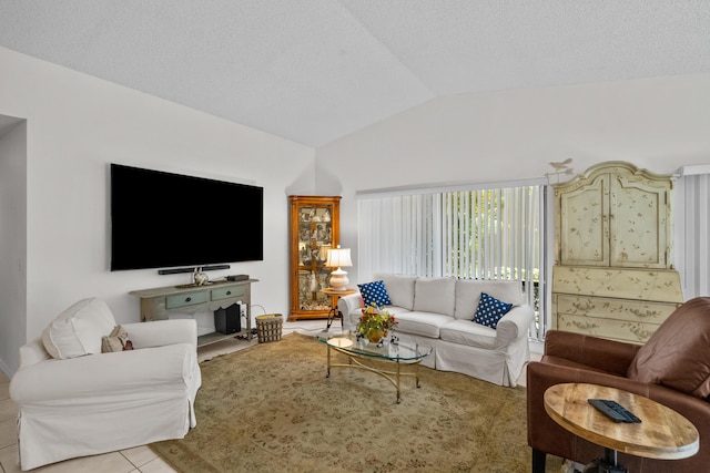 tiled living room featuring vaulted ceiling and a textured ceiling