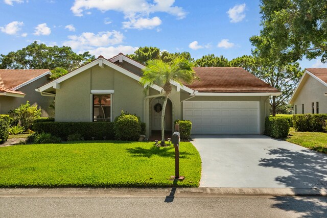 ranch-style home with a garage and a front lawn