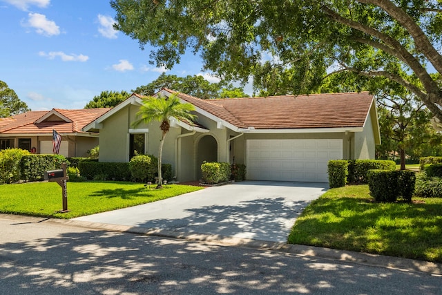 single story home featuring a garage and a front lawn