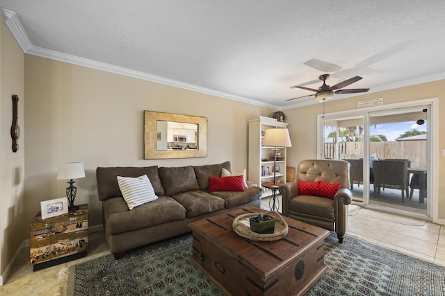 living room featuring tile patterned flooring, ornamental molding, a textured ceiling, and ceiling fan